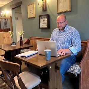 A man sat working in The White Swan pub